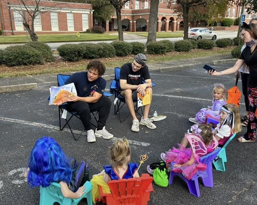 Students reading to school children